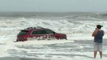 Jeep abandoned on Myrtle Beach as Hurricane Dorian rages; onlookers take selfies