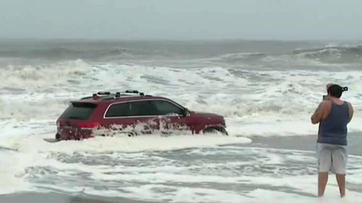 Hurricane Dorian's waves swamp SUV in Myrtle Beach, S.C.