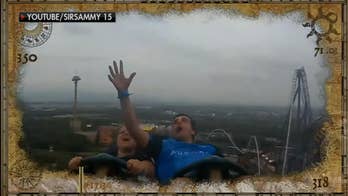 Man catches flying phone while riding roller coaster, amazing video shows