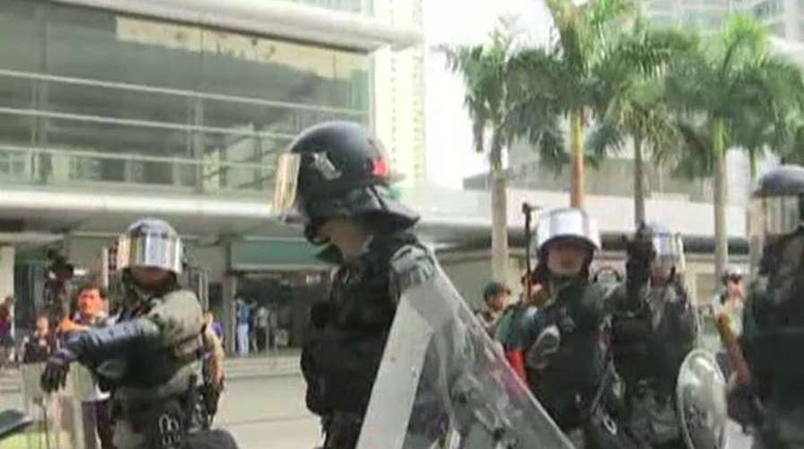 Hong Kong riot police take on protesters as street demonstrations continue