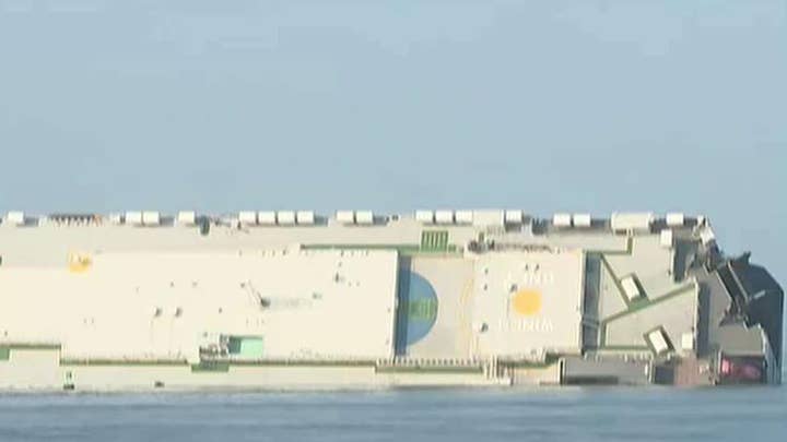 4 crew members missing from flipped cargo ship