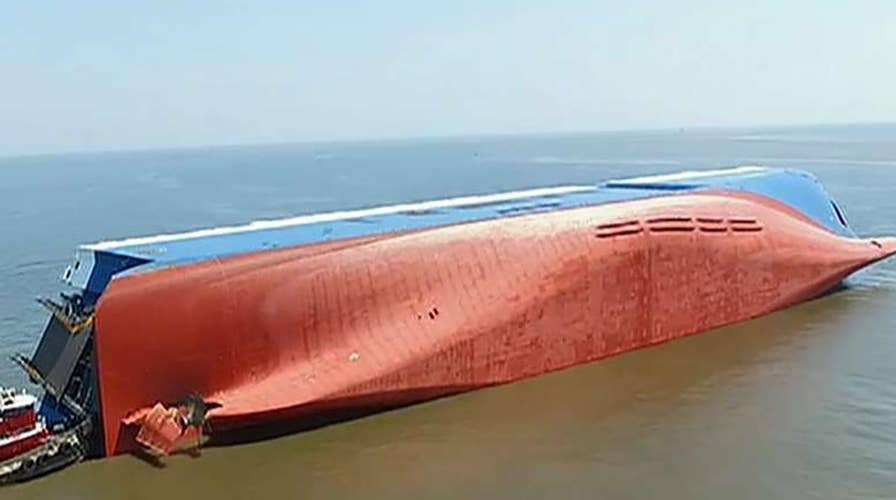 Search for missing crew continues after cargo ship overturns near Georgia port