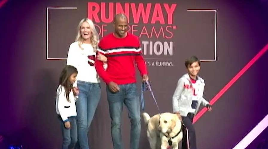 8-year-old boy and Canine Companions service dog walk runway to showcase adaptive clothing