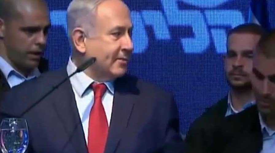 Israeli security forces rush Prime Minister Benjamin Netanyahu from stage after rockets were fired into Israel
