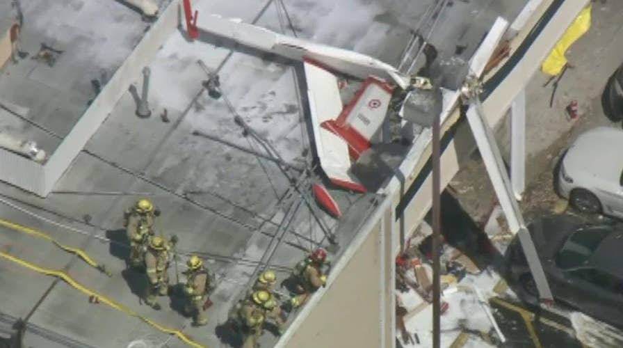 1 dead, 1 critically injured after small plane crashes into a roof in