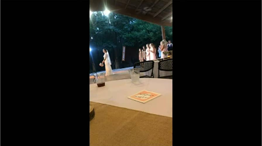 Watch: Wedding guest flees reception after girlfriend catches bride's bouquet