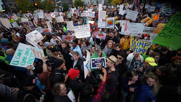 Protesters light MAGA hats on fire outside of 'Keep America Great' rally in Minnesota