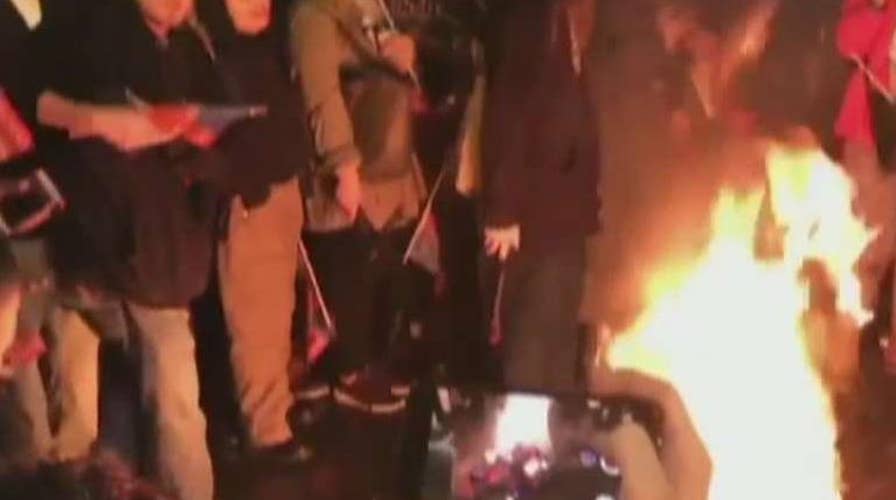 Trump protesters torch MAGA hats, throw objects at police outside Minneapolis rally