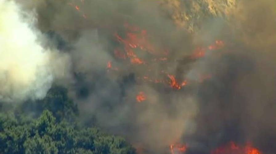 Wind-driven wildfire explodes north of Los Angeles