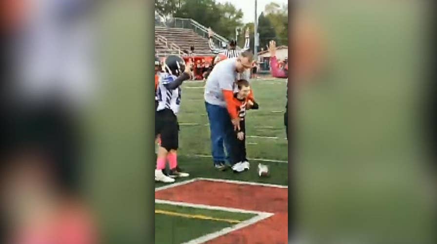 7-year-old boy with cerebral palsy becomes honorary football captain for a day