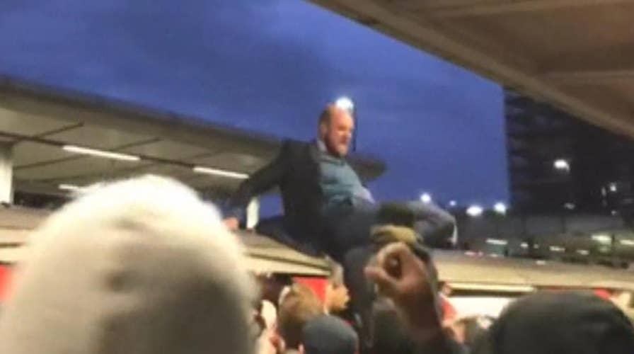 Climate protesters climb on top of train, clash with commuters in London