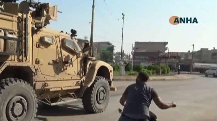 Kurdish protesters throw rocks, potatoes at departing US troops