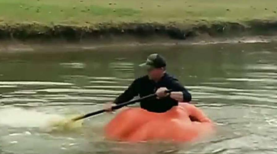 Man uses giant pumpkin as a boat