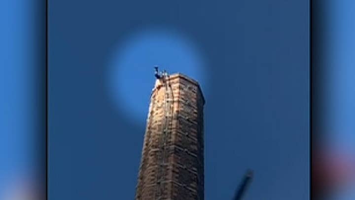 Man stuck on top of 290-foot tall smokestack dies