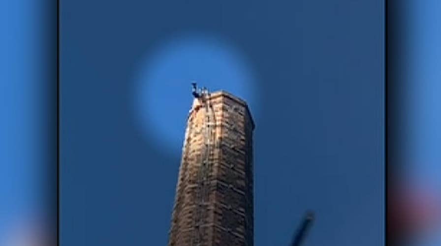 Man stuck on top of 290-foot tall smokestack dies