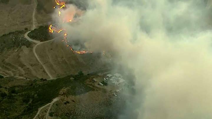 Fast-moving brush fire threatens homes near Reagan Library in Southern California