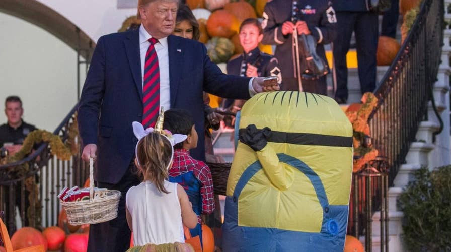 Internet reacts to Trump putting candy on top of child’s Halloween costume