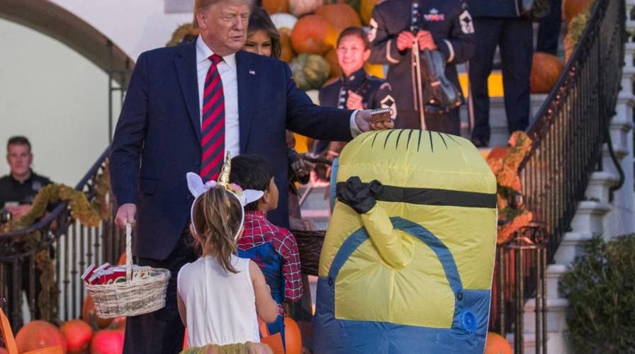 Internet reacts to Trump putting candy on top of child’s Halloween costume