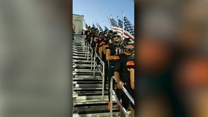 Texas high school football team carry flags to honor military, police officers during game