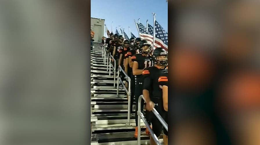 Texas high school football team carry flags to honor military, police officers during game
