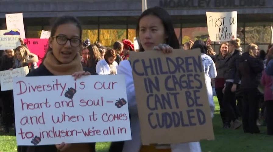Protesters gather outside Boston Medical Center during a visit from first lady Melania Trump
