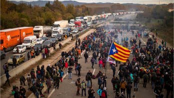 Catalan protesters snarl traffic, burn barricades in major Spain highway