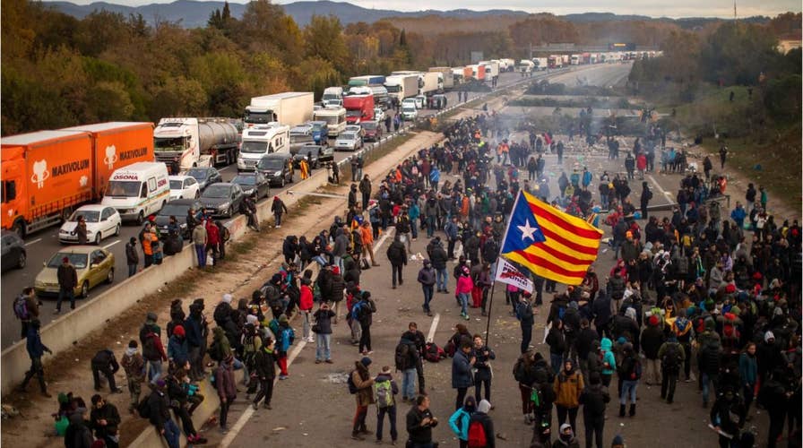 Catalan protesters snarl traffic, burn barricades in major Spain highway
