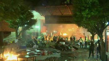 Hong Kong protesters set fire to polytechnic university entrance as police attempt to move in