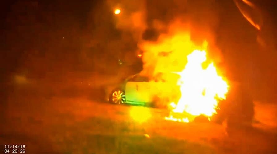 Woman cut out of burning car