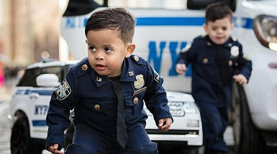 Adorable toddler ‘NYPD lieutenant’ twins travel the country to honor police officers and those who serve