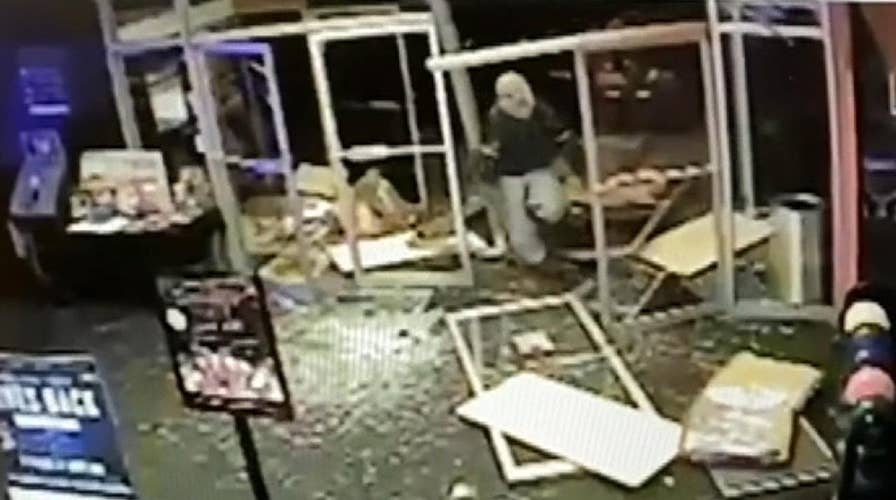 Police search for suspect who kidnapped a woman, stole her car and slammed it into a bowling alley