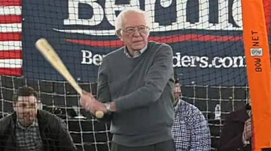 Bernie Sanders holds batting practice while meeting with Minor League Baseball players