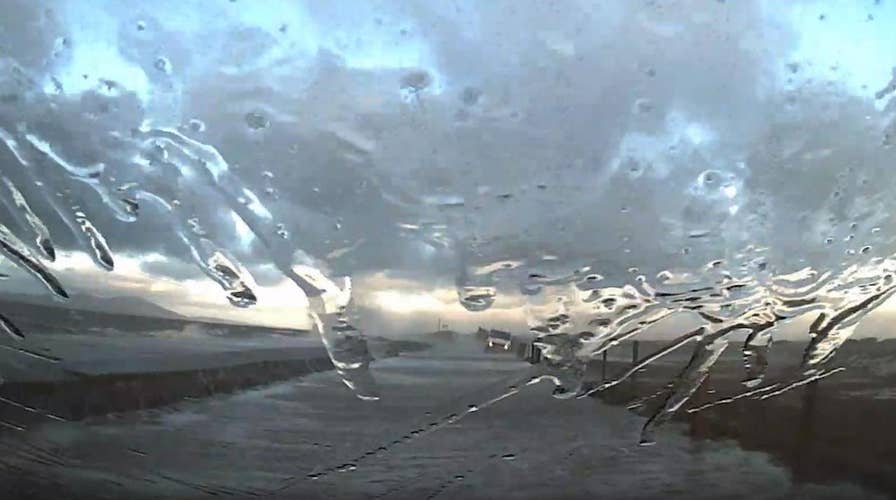 Car slammed by waves escapes flood in dramatic dashcam video