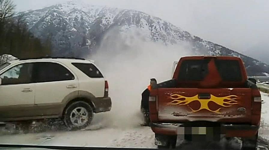 Tow truck driver nearly slammed by a swerving vehicle on icy road