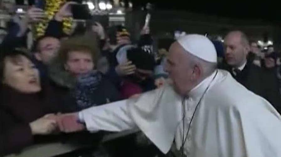 Pope apologizes for smacking hand of woman who grabbed him