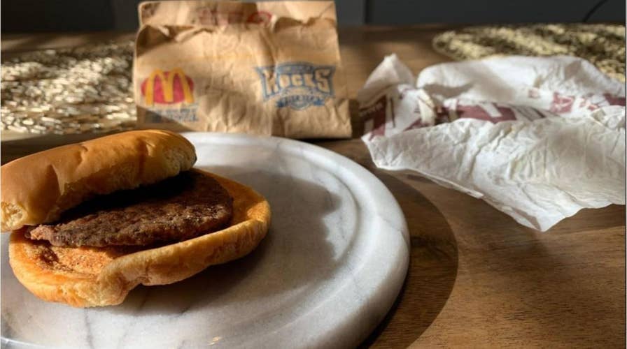 A Utah man unveils a hamburger he purchased from McDonald’s in 1999