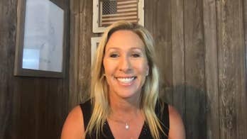 GOP candidate Marjorie Greene faces backlash over image of herself holding gun alongside The Squad