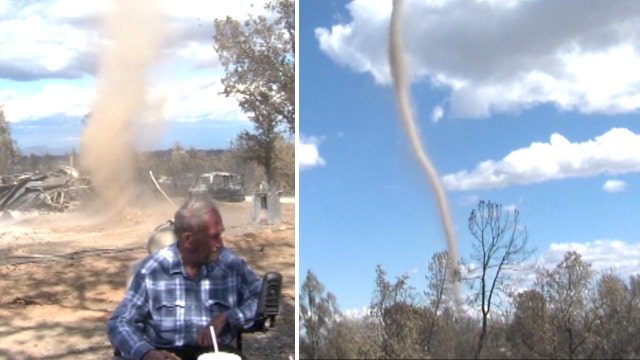 Dust devil whips up sand in front of folks in California