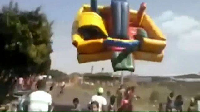 Dust devil rips bounce house, boy into the air