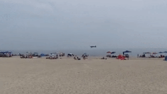 Plane crashes into ocean as people watch in shock on busy beach