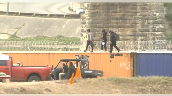 Illegal immigrants stream over the US border at Eagle Pass, Texas