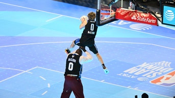 Athlete stuns NBA's Slam Dunk contest by jumping over 7-foot Shaquille O'Neal