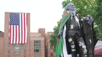 Huge American flag proudly unfurled behind defaced George Washington statue