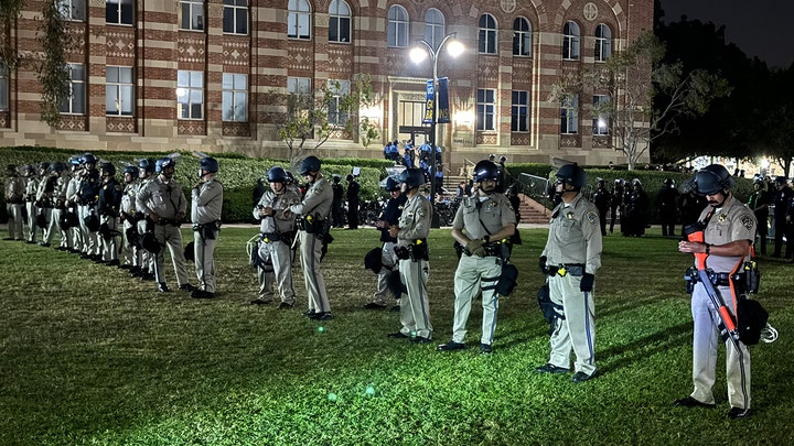 Riot police clash head-on with left-wing mob after breaking through barrier on UCLA campus