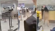 Naked woman walks through airport in fit over visa issue