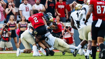 College quarterback carted off the field after hit sends helmet flying - Fox News
