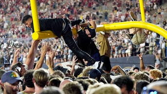 Fans on field goal post - Fox News