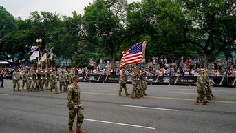 Soldiers walking with flag - Fox News