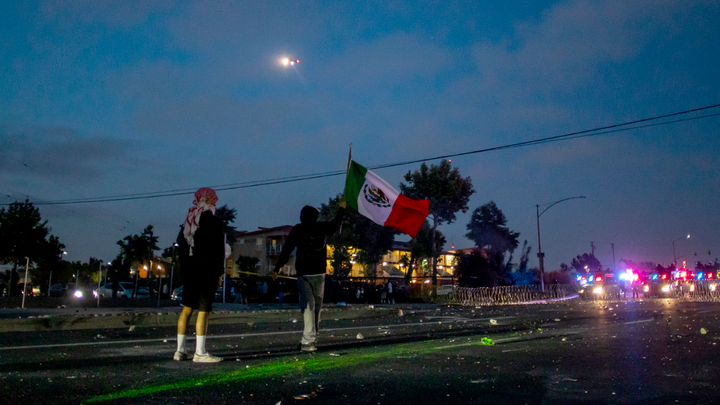 LA protesters standing in street with flags - Fox News
