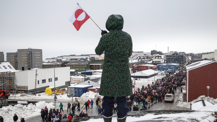 Back of green coat holding flag - Fox News